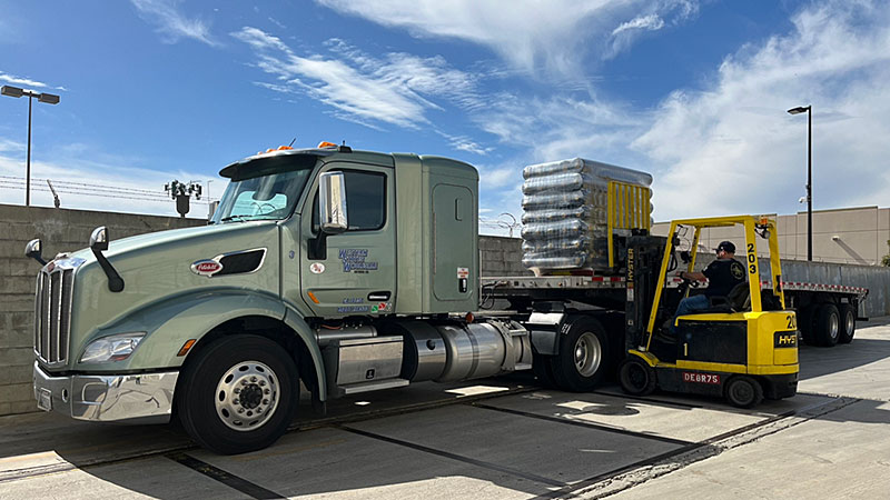 Semi Truck being loaded by a forklift